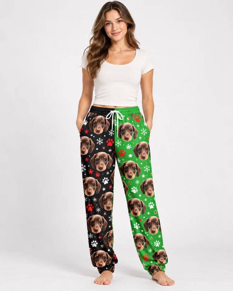 Custom pajama pants printed all over with dachshund faces on a black and green snowflake print
